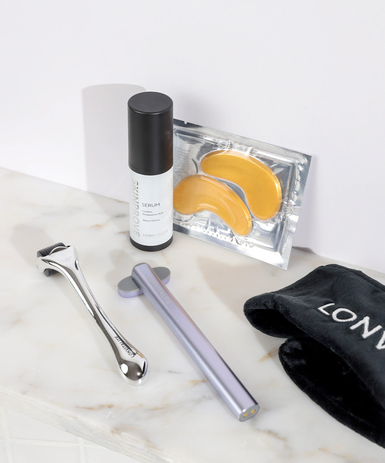 LONVITALITE PRO LED Facial Wand accessories displayed on a marble surface